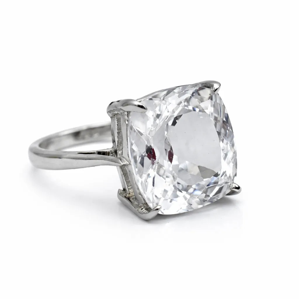 Silver ring with a large clear gemstone on a white background