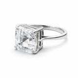 Silver ring with a large rectangular diamond on a white background