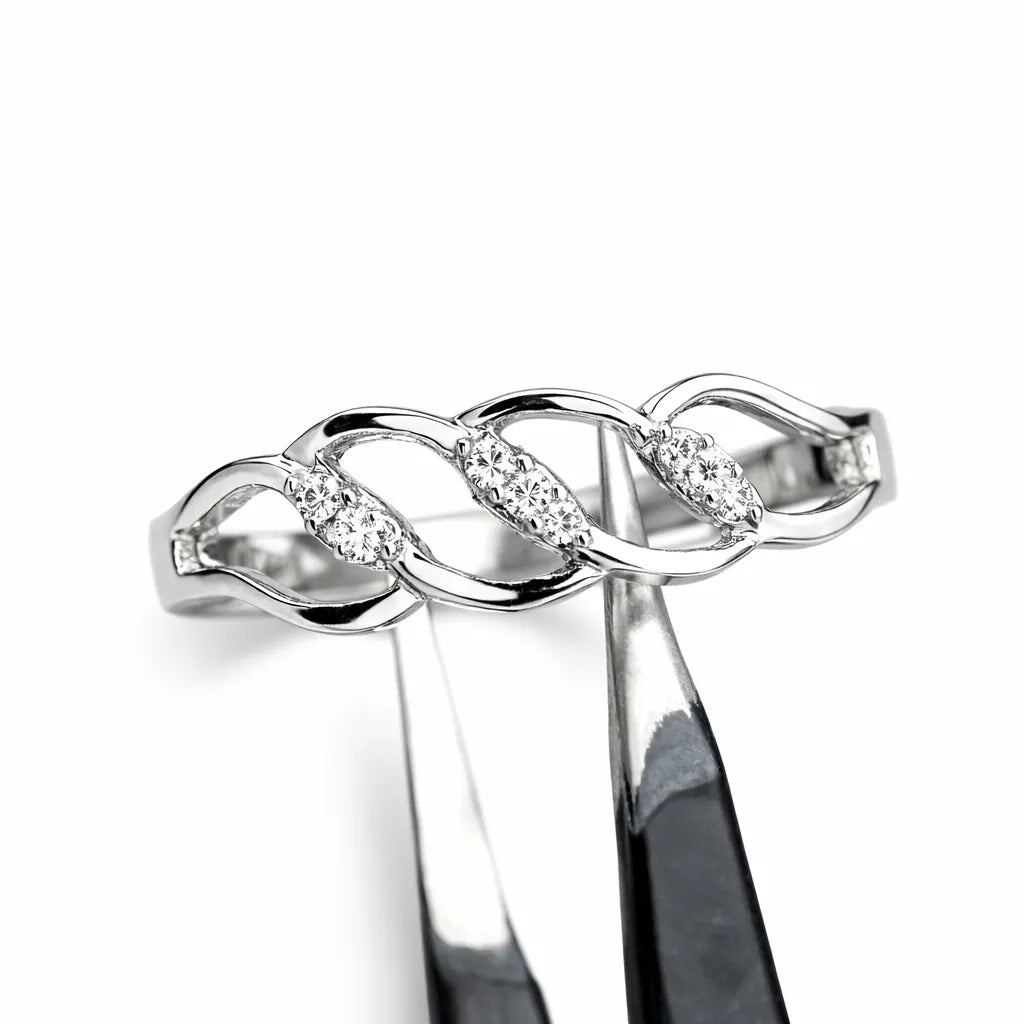 Silver infinity ring with embedded diamonds on a white background