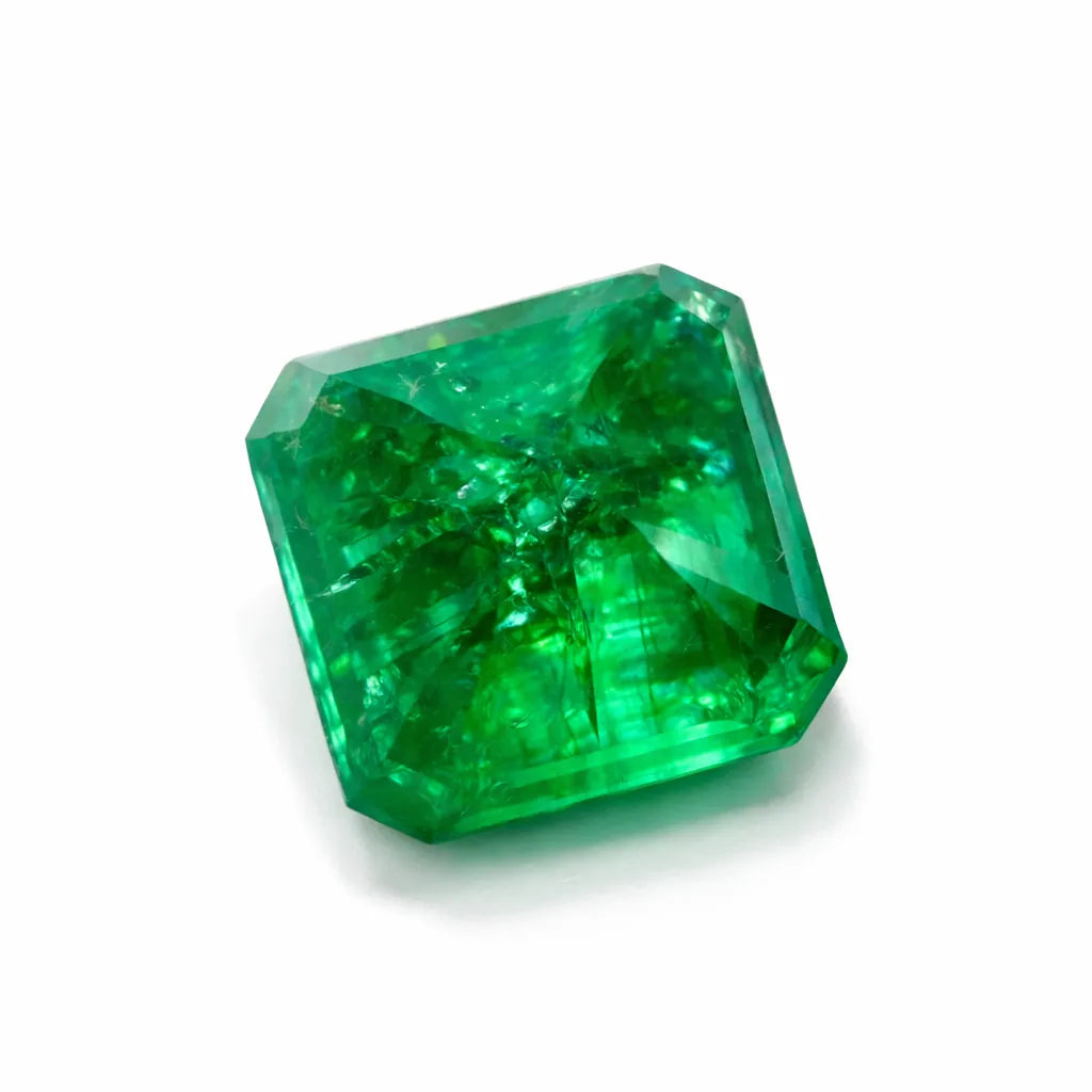 Certified Natural Emerald Loose Gemstone Faceted green gemstone on a white background